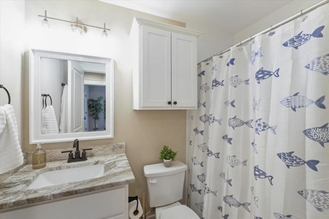 bathroom featuring vanity, toilet, and a shower with shower curtain