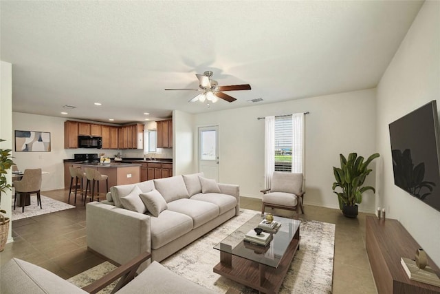 living room featuring tile patterned flooring and ceiling fan