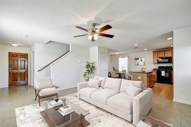 living room with light tile patterned floors and ceiling fan