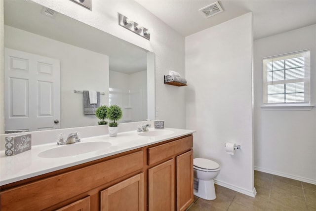 bathroom featuring tile patterned flooring, vanity, and toilet