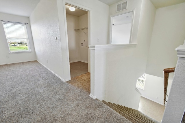 hallway with light colored carpet