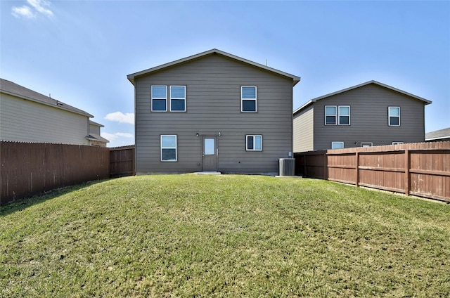 back of house featuring central AC unit and a lawn