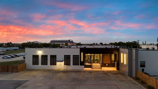 back house at dusk featuring a patio area