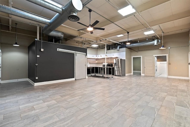 interior space featuring ceiling fan and stainless steel fridge