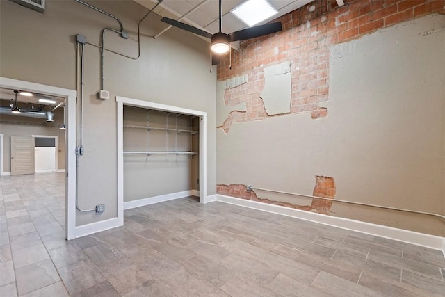 unfurnished bedroom with a towering ceiling and a closet