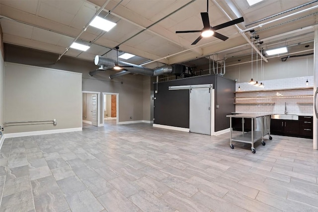 interior space with sink and ceiling fan