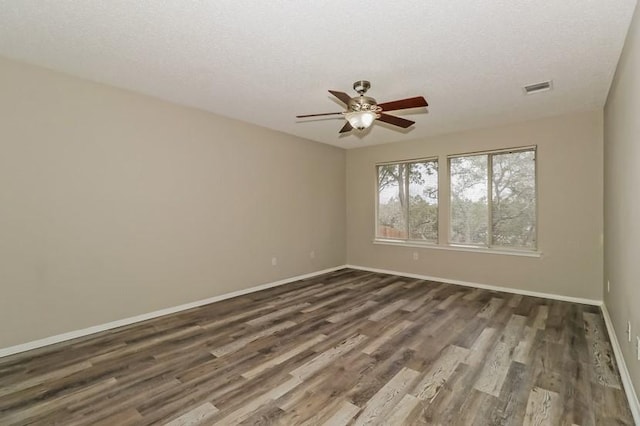 6333 La Mesa St, Leander, TX 78645 - empty room with ceiling fan, dark wood-type flooring, and a textured ceiling