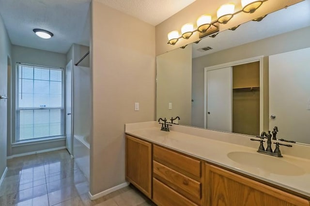 6333 La Mesa St, Leander, TX 78645 - full bath featuring double vanity and tile patterned flooring