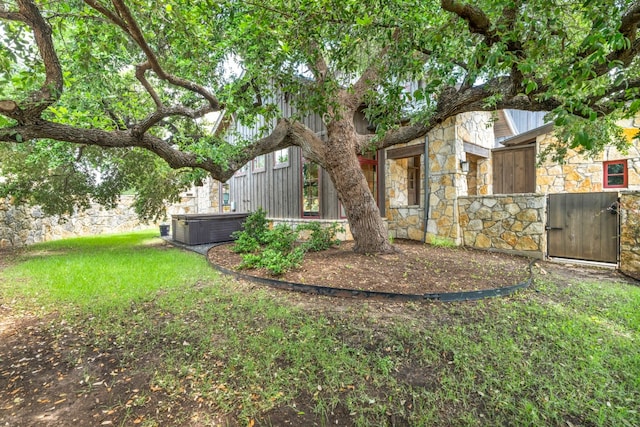 view of yard featuring a hot tub and central air condition unit