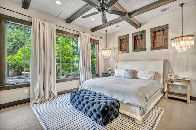 bedroom featuring beamed ceiling, ceiling fan with notable chandelier, and light hardwood / wood-style floors