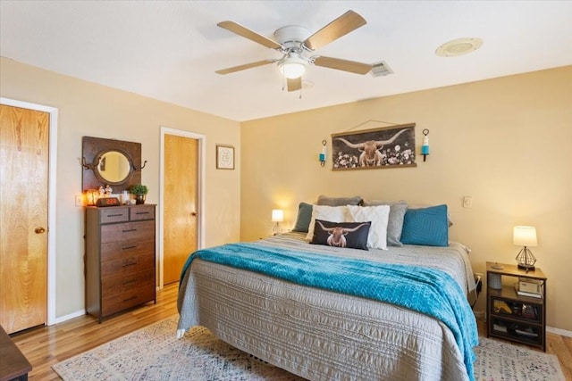 bedroom featuring ceiling fan and light hardwood / wood-style flooring