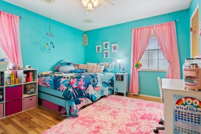 bedroom featuring hardwood / wood-style flooring and ceiling fan