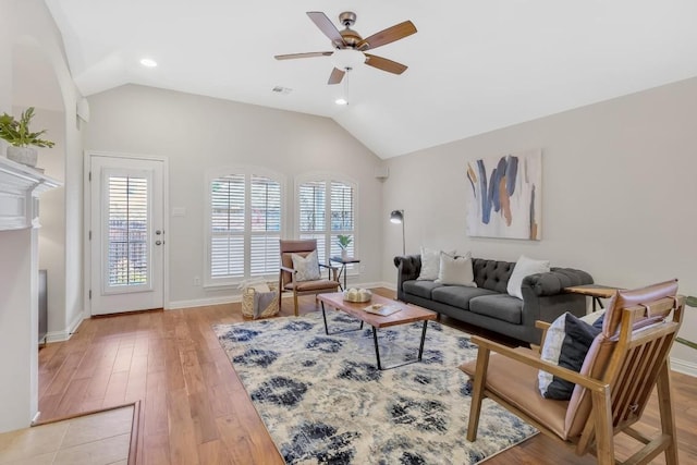 living room featuring plenty of natural light, ceiling fan, and vaulted ceiling