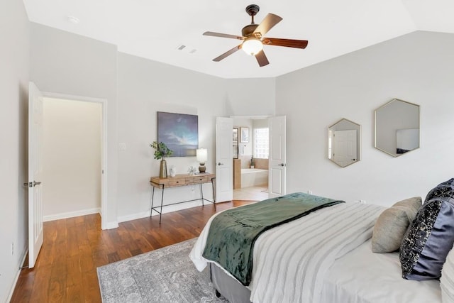 bedroom featuring wood-type flooring, lofted ceiling, ceiling fan, and ensuite bath