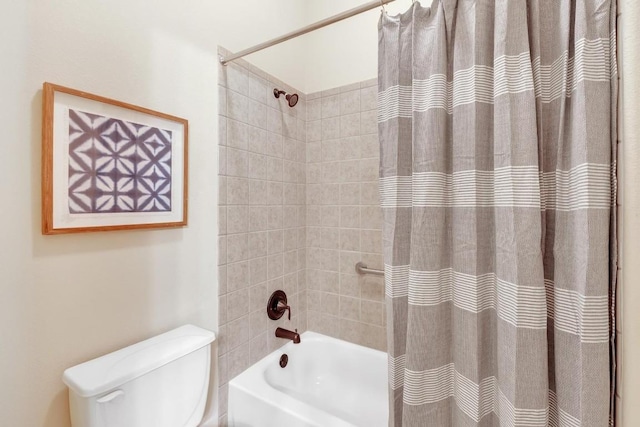 bathroom with shower / tub combo with curtain and toilet