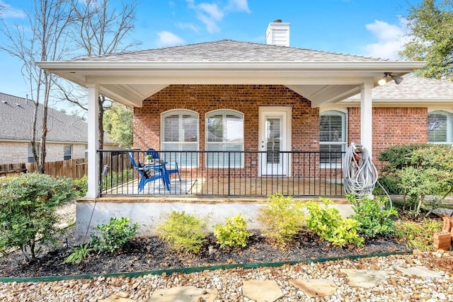 back of property featuring covered porch