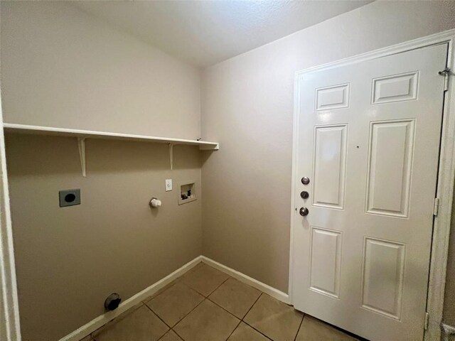 clothes washing area with gas dryer hookup, washer hookup, light tile patterned floors, and electric dryer hookup