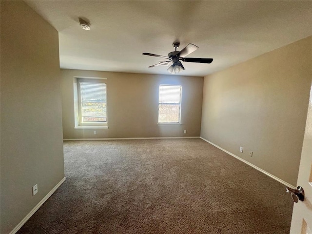 carpeted spare room with ceiling fan