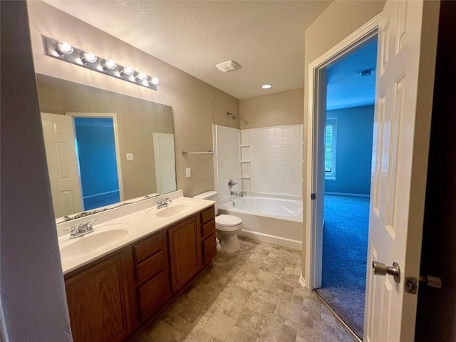 full bathroom featuring shower / washtub combination, vanity, a textured ceiling, and toilet