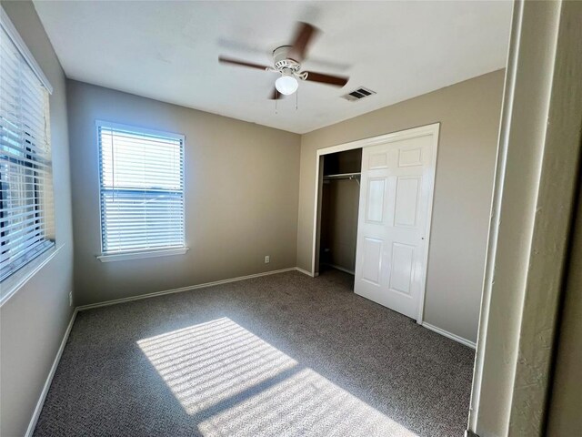 unfurnished bedroom with a closet, ceiling fan, and carpet flooring