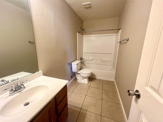 full bathroom with tile patterned flooring, vanity, shower / washtub combination, and toilet