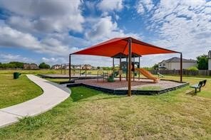 view of playground with a lawn