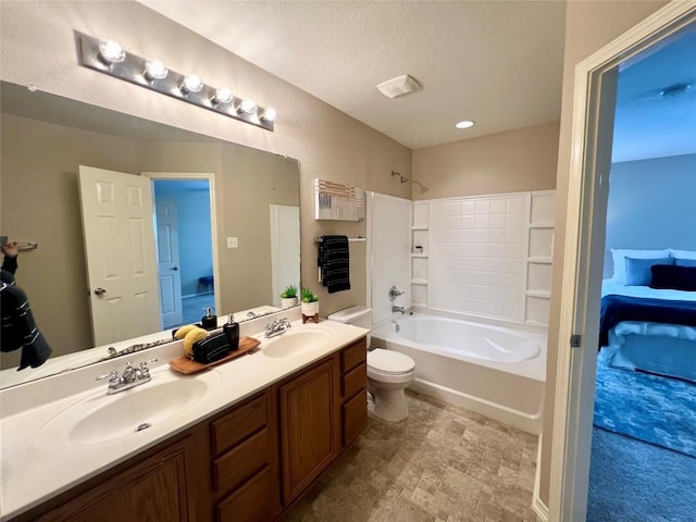 full bathroom with bathing tub / shower combination, vanity, a textured ceiling, and toilet