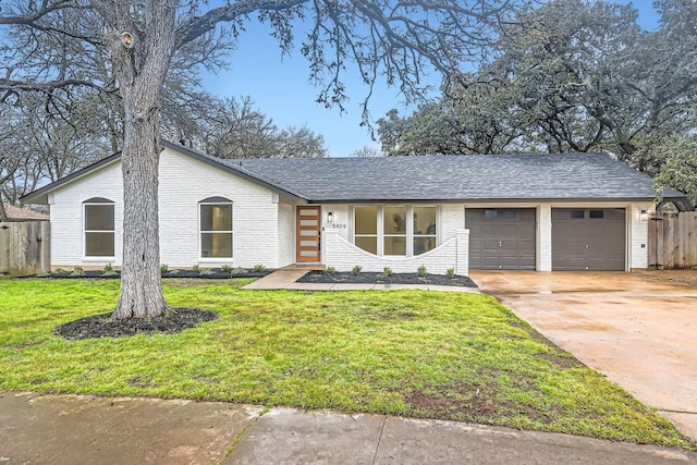 ranch-style home featuring a garage and a front yard