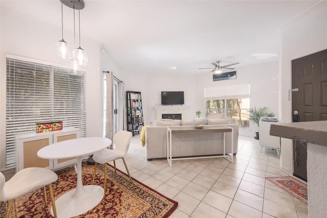 tiled living room with ceiling fan