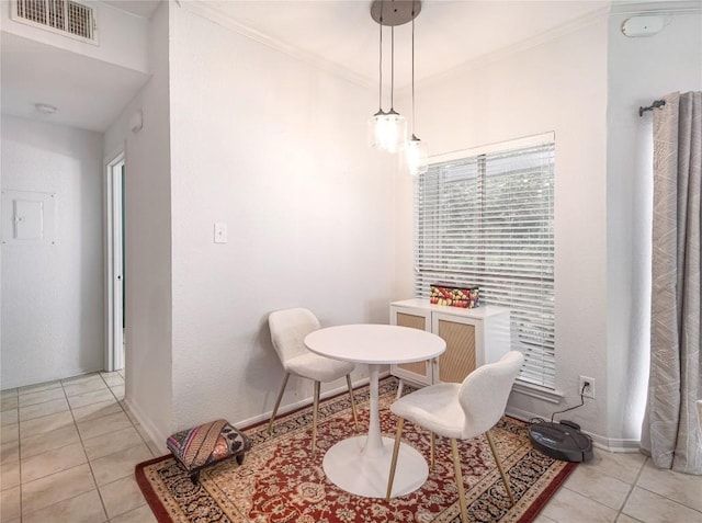 living area with light tile patterned flooring and ornamental molding