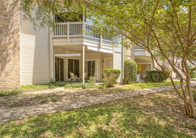 rear view of house featuring a balcony