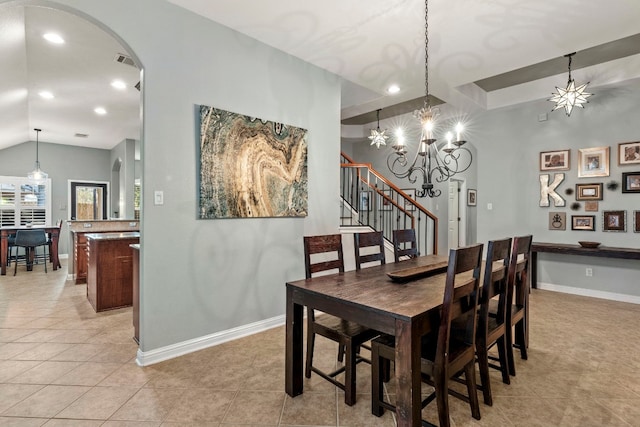 tiled dining space featuring lofted ceiling and a notable chandelier