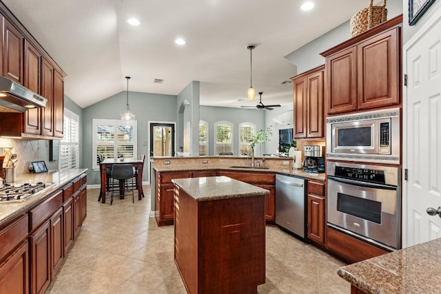 kitchen with sink, appliances with stainless steel finishes, hanging light fixtures, a kitchen island, and kitchen peninsula