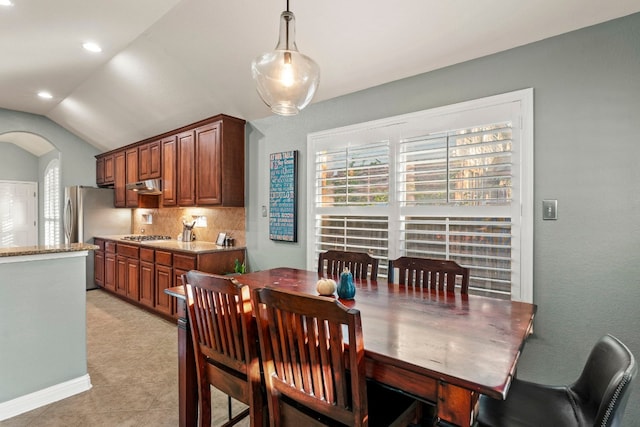 tiled dining area featuring lofted ceiling