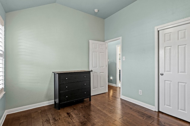 bedroom featuring lofted ceiling and dark hardwood / wood-style floors