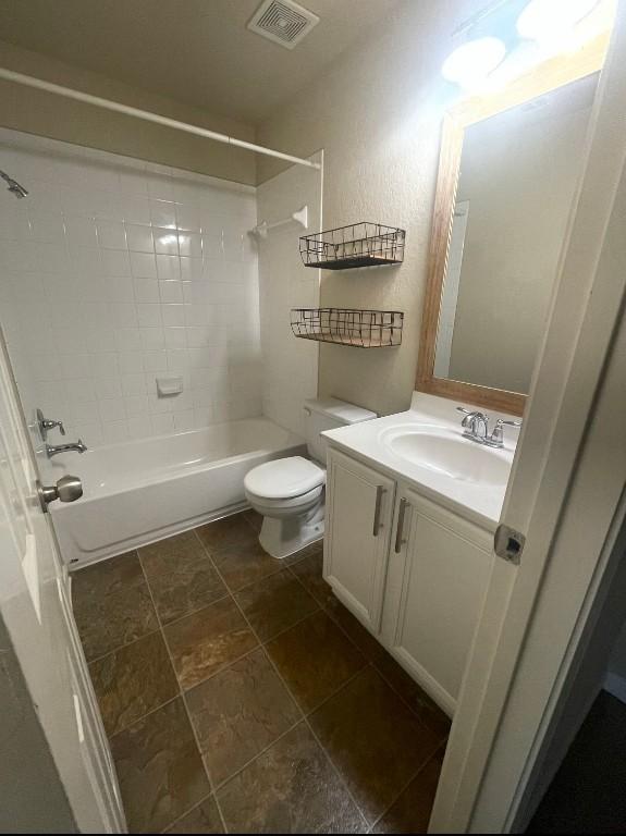 full bathroom featuring vanity, toilet, and tiled shower / bath