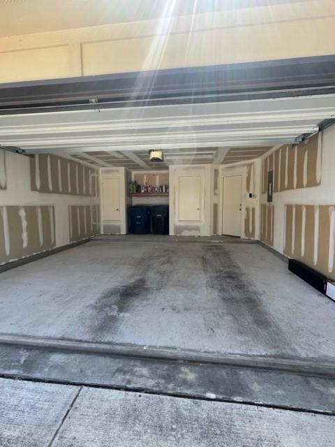 garage with a garage door opener and a carport