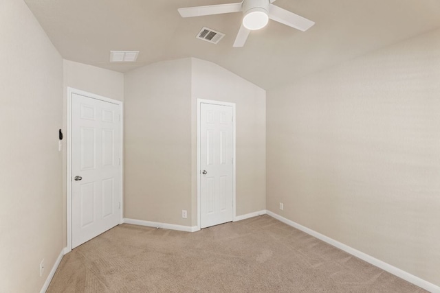 unfurnished bedroom with light carpet, baseboards, visible vents, a ceiling fan, and lofted ceiling