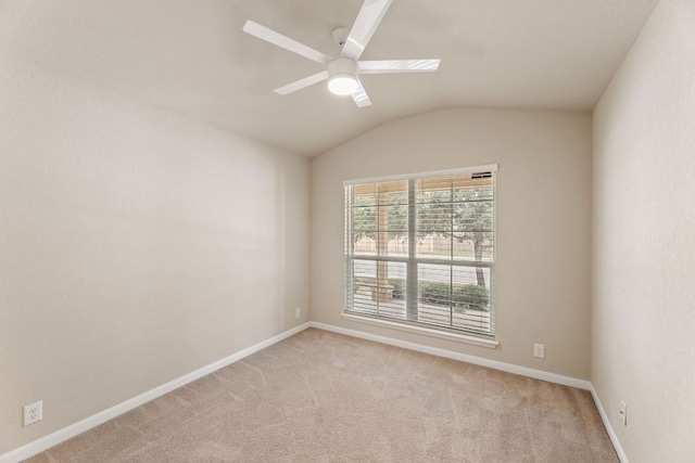 unfurnished room with ceiling fan, baseboards, vaulted ceiling, and light colored carpet