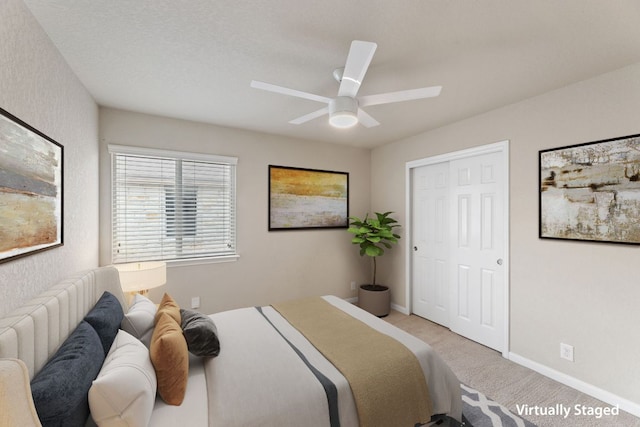 bedroom with carpet floors, a closet, ceiling fan, and baseboards