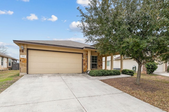 ranch-style house with concrete driveway, stone siding, and an attached garage