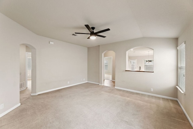 empty room featuring carpet, visible vents, and baseboards