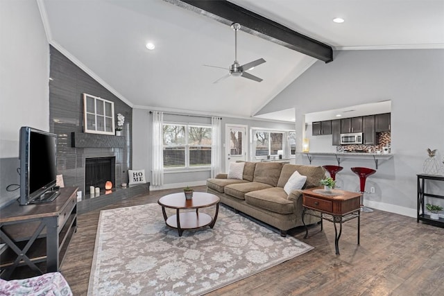 living room featuring crown molding, a brick fireplace, dark wood-type flooring, and beam ceiling