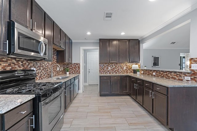 kitchen with crown molding, appliances with stainless steel finishes, sink, and decorative backsplash