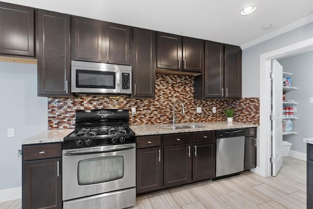 kitchen featuring tasteful backsplash, sink, dark brown cabinets, and appliances with stainless steel finishes