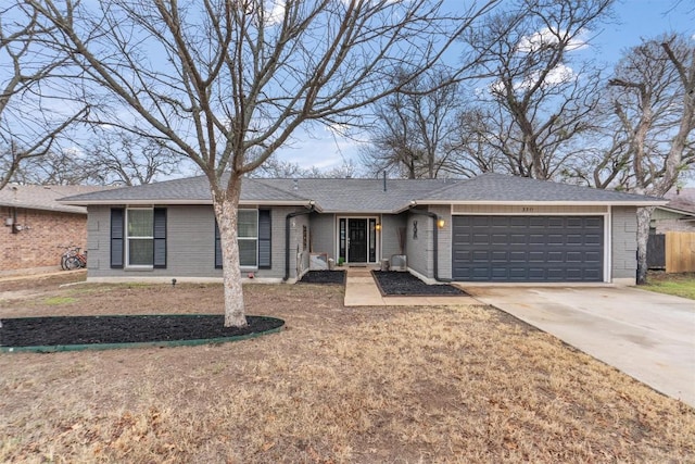 ranch-style home with a garage and a front lawn