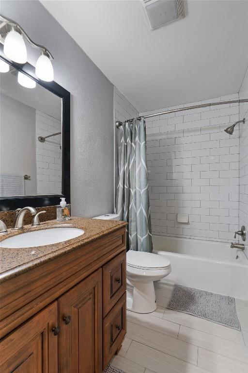 full bathroom with vanity, toilet, and shower / bath combo