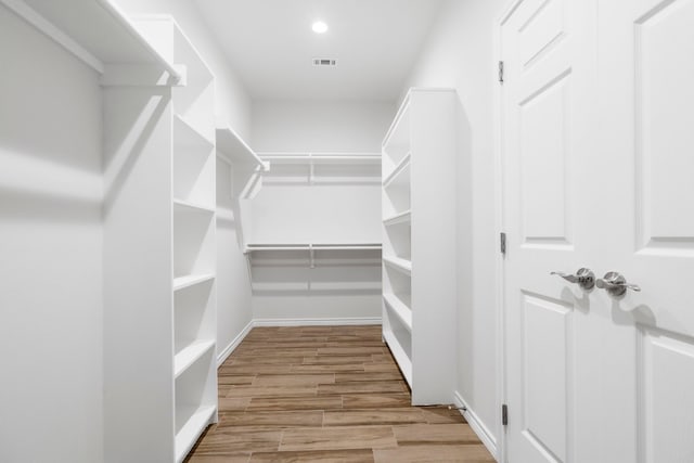 walk in closet featuring light hardwood / wood-style flooring