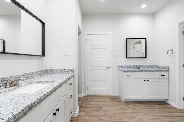 bathroom with hardwood / wood-style flooring and vanity