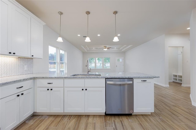 kitchen with white cabinetry, stainless steel dishwasher, sink, and light stone counters